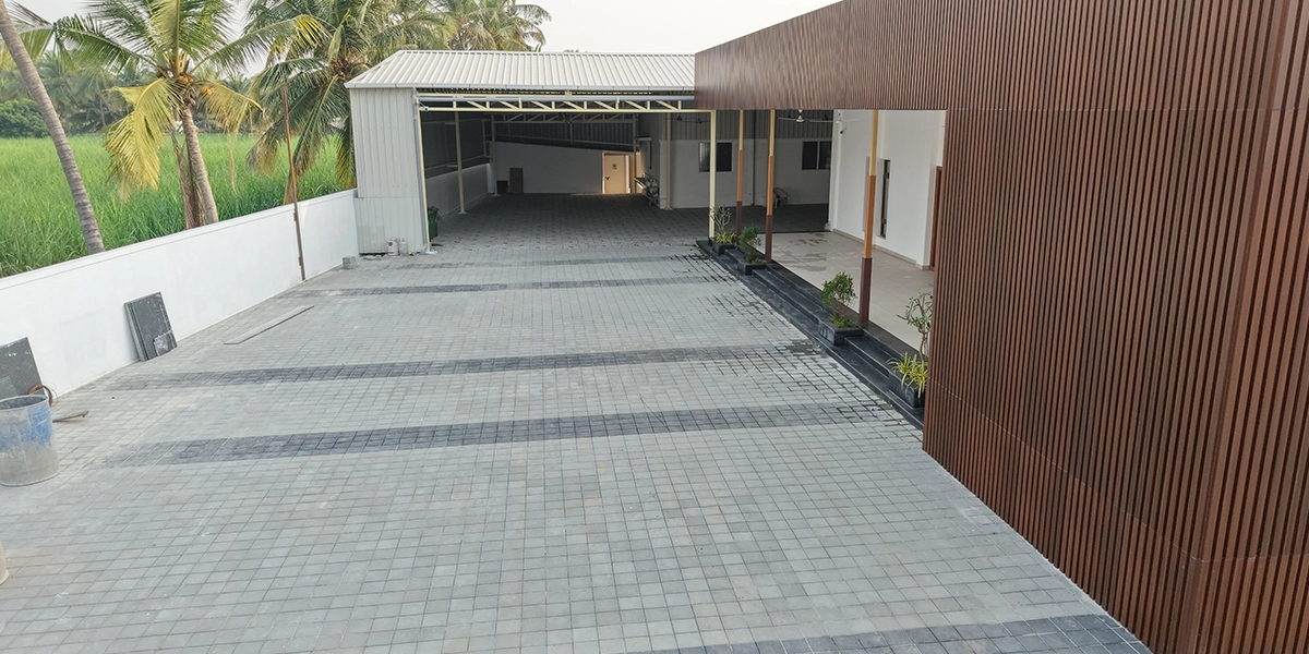 Backside view of the mahal showing open space, structural design, and convenient service access areas