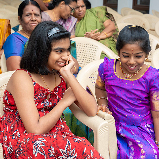 Children happily enjoying wedding festivities surrounded by family and joyful atmosphere