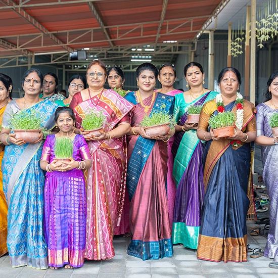 Family members holding traditional plant symbolizing prosperity during auspicious ceremonies
