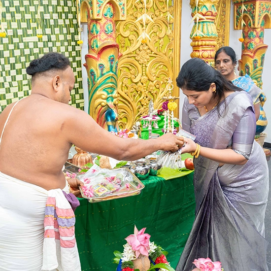 People receiving divine blessings during sacred rituals at traditional family and cultural functions
